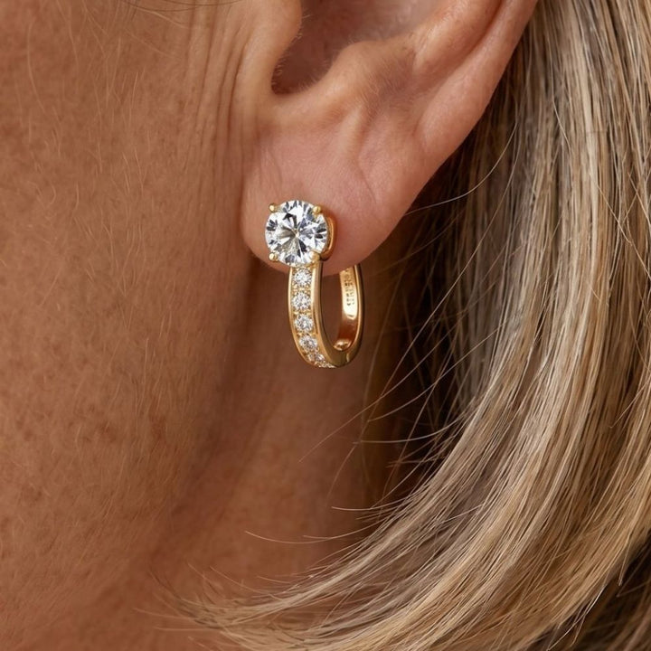 "Pendientes Huggie Elegantes" can be rewritten in Spanish as "Pendientes Huggie Sofisticados".